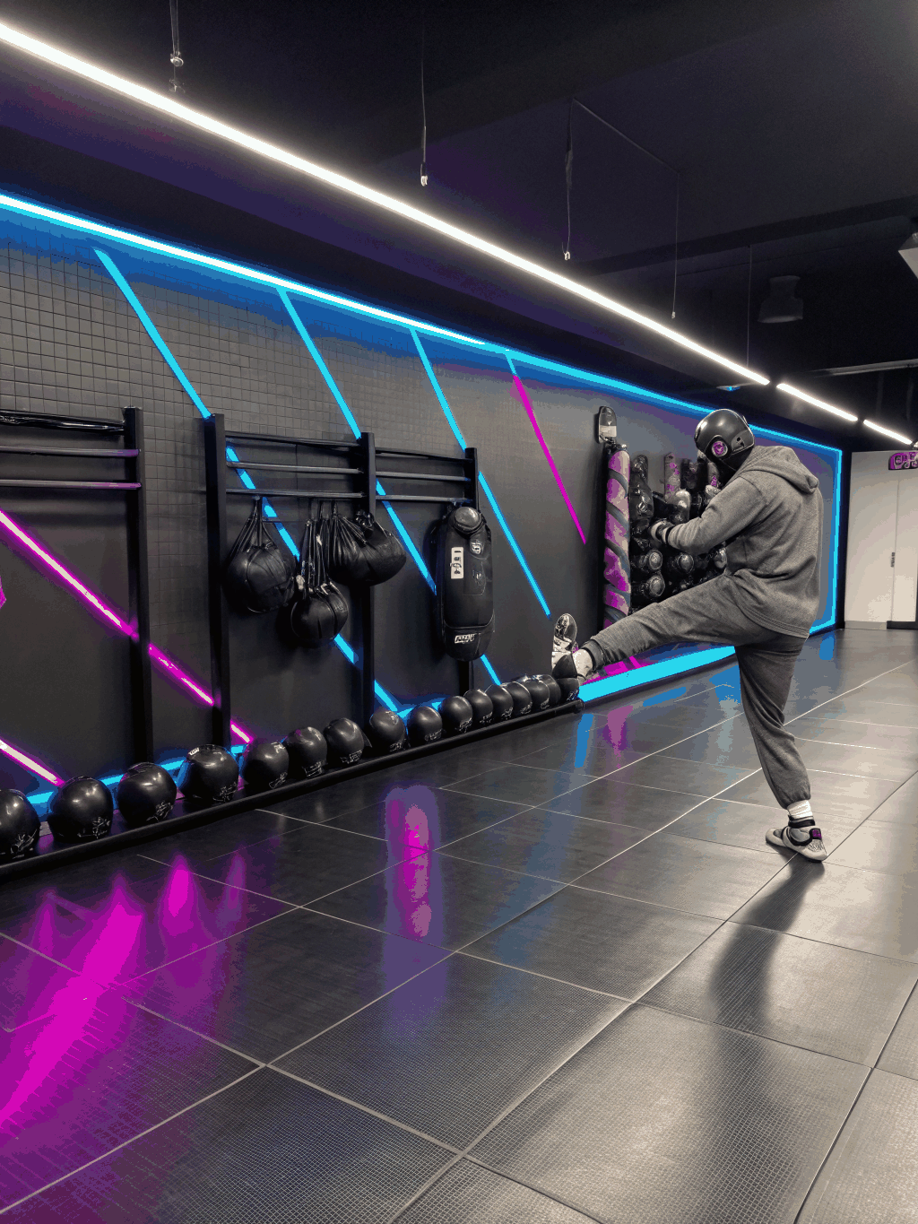OKBLive virtual kickboxing studio — professional lighting, high-energy atmosphere, instructor leading a live session